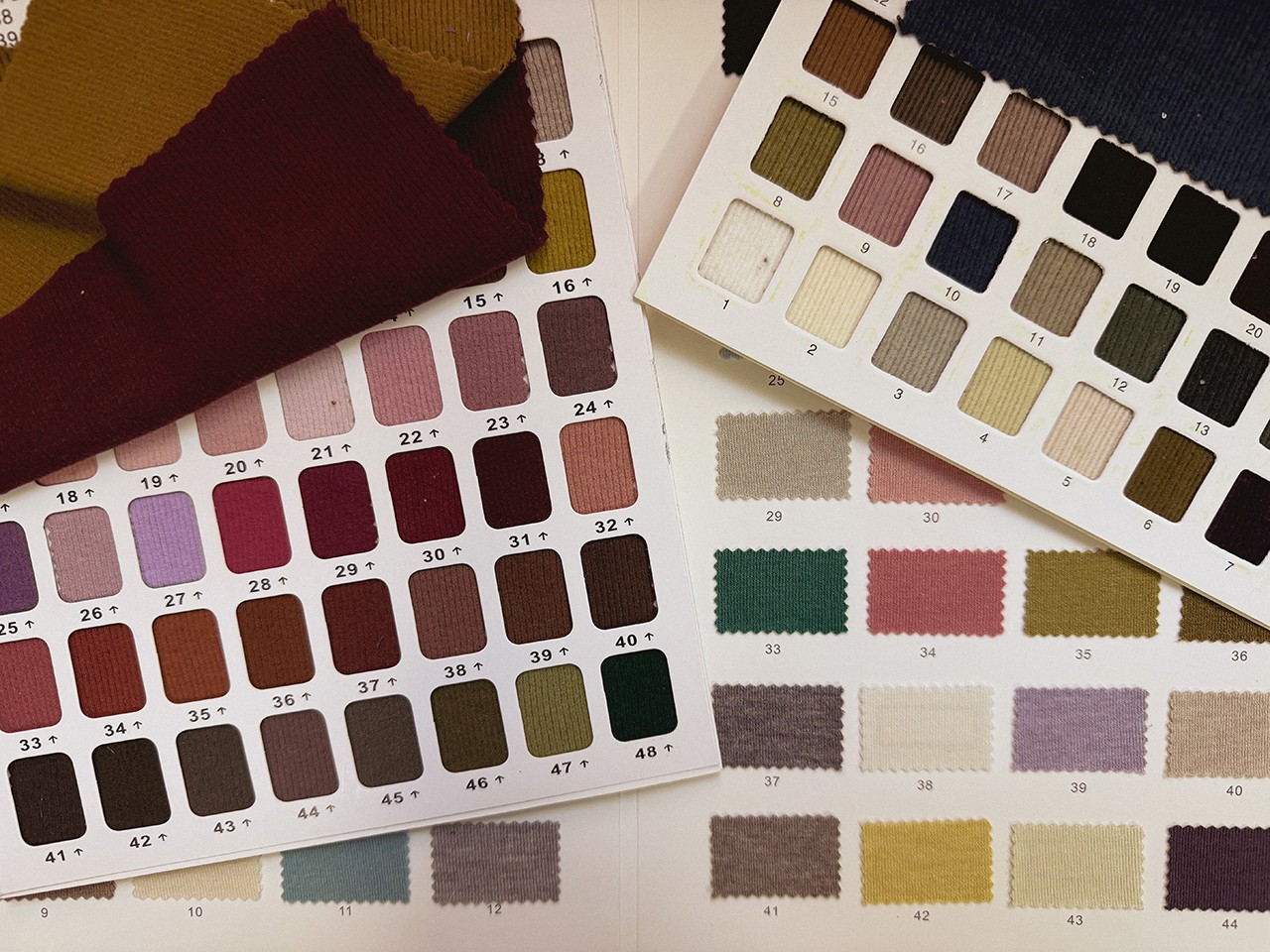 Photo of various fabric swatches in a swatch book.